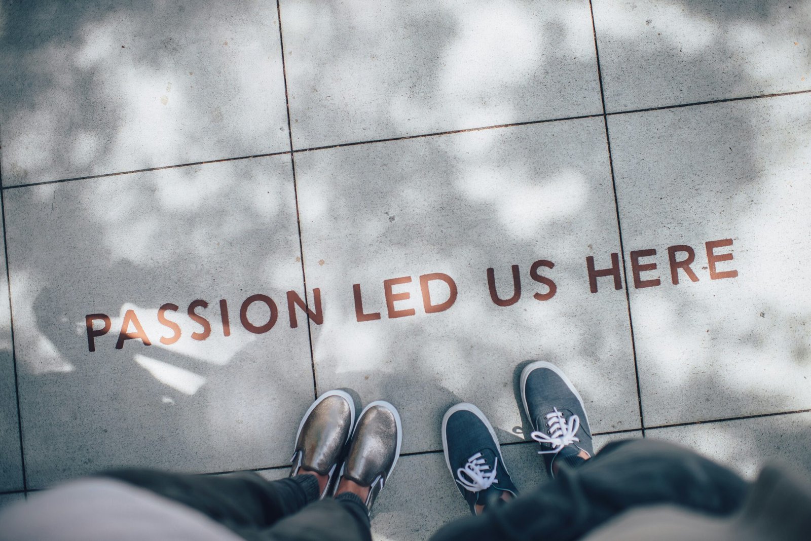 A photo of two people standing above text that reads "Passion led us here" to symbolize the beginning of my journey with this blog.